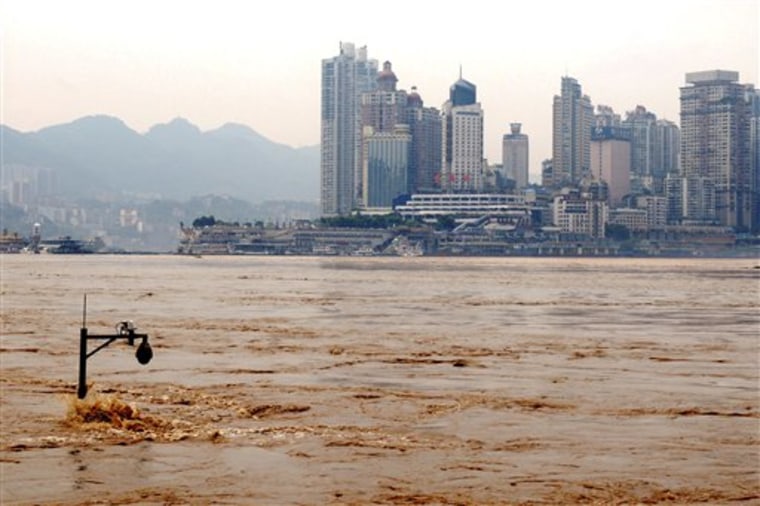 A street lamp is partially emerged by the flooded Yangtze River in southwest China's Chongqing city, on Tuesday.